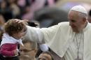Pope Francis blesses a child during the weekly general audience in St. Peter's Square, at the Vatican, Wednesday, Oct. 9, 2013. (AP Photo/Gregorio Borgia)