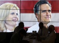 Convention goers enjoy their pizza lunch in front of a large video screen showing Republican presidential candidate Mitt Romney and his wife Ann, during the second session of the 2012 Republican National Convention in Tampa, Florida, August 28, 2012. REUTERS/Rick Wilking (UNITED STATES  - Tags: POLITICS ELECTIONS)