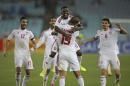 Team mates celebrate UAE's Ismail Ahmed's penalty shot that advances them to the semifinals at the end of the AFC Asia Cup soccer quarterfinal match between Japan and United Arab Emirates in Sydney, Australia, Friday, Jan. 23, 2015. (AP Photo/Rick Rycroft)