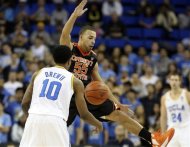 Oregon State guard Roberto Nelson (55) blocks a pass by UCLA guard Larry Drew II (10) in the first half of an NCAA college basketball game in Los Angeles, Thursday, Jan. 17, 2013. (AP Photo/Reed Saxon)