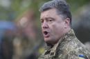 Ukrainian President Petro Poroshenko addresses Ukrainian troops as he visits their base in Devhenke village, Kharkiv region, eastern Ukraine, Tuesday, July 8, 2014. President Petro Poroshenko suggested, meanwhile, that mediation could take place in a government-controlled town some 220 kilometers west of Russia_ a proposal staunchly rejected by the rebels. (AP Photo/Evgeniy Maloletka)