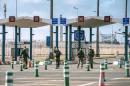 Military personnel patrol at the checkpoint of the frontier police at the northern French port city of Calais