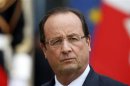 French President Francois Hollande stands on the steps of the Elysee Palace in Paris