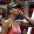 Russia's Sharapova blows a kiss to the crowd after winning her second round women's singles match against Romania's Cirstea at the China Open tennis tournament in Beijing