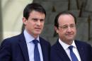 French President Hollande escorts newly-named Prime Minister Valls after the first cabinet meeting of the new government at the Elysee Palace in Paris