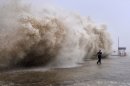 A man running away from a huge wave in Shantou, southern China September 22, 2013