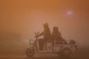 People ride during heavy smog in Lianyungang