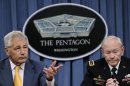 Defense Secretary Chuck Hagel, left, accompanied by Joint Chiefs Chairman Gen. Martin E. Dempsey, answers a question during a news conference at the Pentagon, Wednesday, June 26, 2013. Hagel, following the Supreme Court ruling that same-sex couples should get the same federal benefits as heterosexual couples, said the Pentagon would begin the process to extend benefits to the same-sex spouses of military members as soon as possible. (AP Photo/Susan Walsh)