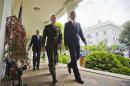 President Barack Obama walks with Marine Gen. Joseph Dunford Jr., his nominee to be the next chairman of the Joint Chiefs of Staff, after speaking in the Rose Garden of the White House in Washington, Tuesday, May 5, 2015. Obama chose the widely respected, combat-hardened commander who led the Afghanistan war coalition during a key transitional period during 2013-2014 to succeed Army Gen. Martin Dempsey. Walking behind them is Vice President Joe Biden. (AP Photo/Pablo Martinez Monsivais)