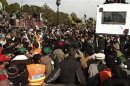 Supporters of Sufi cleric and leader of Minhaj-ul-Quran Qadri gather around as he addresses them on the second day of protests in Islamabad