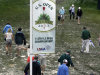 Spectators make their way down a muddy path during practice for the U.S. Open golf tournament at Merion Golf Club, Monday, June 10, 2013, in Ardmore, Pa. (AP Photo/Gene J. Puskar)