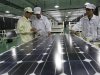 In this photo taken Wednesday March 21, 2012, Chinese workers examine solar panels at a manufacturer of photovoltaic products in Huaibei in central China's Anhui province. China's government on Friday, May 18, 2012,  rejected a U.S. antidumping ruling against its makers of solar power equipment and Chinese manufacturers warned proposed punitive tariffs might hurt efforts to promote clean energy.  (AP Photo) CHINA OUT