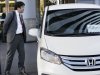 People inspect a Honda vehicle at a Honda Motor Co. showroom in Tokyo Monday, Oct. 31, 2011. Honda says its quarterly earnings tumbled 56 percent from a year earlier, battered by the strong yen and production disruptions from the March tsunami disaster. (AP Photo/Koji Sasahara)