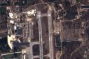 This handout image taken by EADS' Astrium Press on September 20, 2015 by Pleiades Satellite shows a view of Russian fighter jets and helicopters at a military base in the government-controlled coastal Syrian city of Latakia