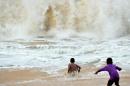 Sri Lankan children play in the surf in the southern coastal town of Peraliya on December 26, 2014