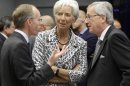 Christine Lagarde, center, managing director of the International Monetary Fund, speaks with Luxembourg's Prime Minister and President of the eurogroup Jean-Claude Juncker, right, and Luxembourg's Economy Minister Luc Freiden during a meeting of eurozone finance ministers in Luxembourg on Thursday, June 21, 2012. As the cracks in the euro currency seem to grow even wider, finance ministers from the 17 countries that use the currency brainstorm Thursday on how to stabilize it. (AP Photo/Virginia Mayo)