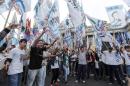 Pro-government demonstrators shout slogans against Argentine Clarin magazine outside the Congress building in Buenos Aires