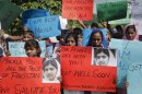 Students hold placards with images of schoolgirl Malala Yousufzai, who was shot by the Taliban, during a rally in Lahore