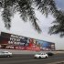 Vehicles travel past a large Bahrain Formula One advertising billboard on main highway leading to Bahrain International Circuit, in Manama