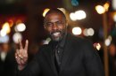 Actor Elba gestures as he arrives for the world premiere of "Les Miserables" in London
