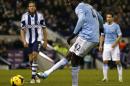 Manchester City's Ivorian midfielder Yaya Toure scores their third goal from the penalty spot at The Hawthorns in West Bromwich, central England on December 4, 2013