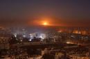 Smoke and flames rise after air strikes on rebel-controlled besieged area of Aleppo, as seen from a government-held side, in Syria