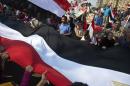 Egyptians wave a giant national flag on Tahrir Square on October 6, 2013 in Cairo