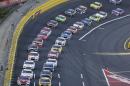 Drivers make their way out of Turn 4 to start the NASCAR Sprint Cup series auto race at Charlotte Motor Speedway in Concord, N.C., Sunday, May 24, 2015. (AP Photo/Gerry Broome)