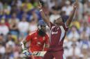 West Indies' Krishmar Santokie celebrates dismissing England's Moeen Ali, left, by LBW during their second T20 International cricket match at the Kensington Oval in Bridgetown, Barbados, Tuesday, March 11, 2014. (AP Photo/Ricardo Mazalan)