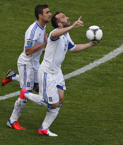 Greece's Fanis Gekas and Yiannis Maniatis, left, celebrate after their team scored during the Euro 2012 soccer championship Group A match between Greece and Czech Republic in Wroclaw, Poland, Tuesday, June 12, 2012. (AP Photo/Anja Niedringhaus)