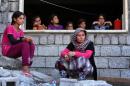 Iraqi Yazidi women who fled the violence in the northern Iraqi town of Sinjar, sit at a school where they are taking shelter in the Kurdish city of Dohuk in Iraq's autonomous Kurdistan region on August 5, 2014
