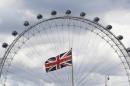A Union Flag flies in front of the London Eye in London