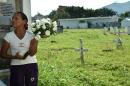 A relative of a victim of the armed conflict in Colombia waits to bury the remains of her loved one in the central cemetery of Villavicencio on December 17, 2015