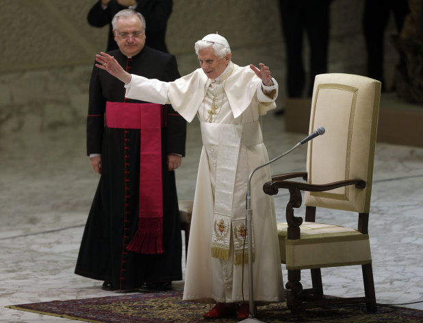 Pope Benedict XVI, right, acknowledges the crowd during his weekly general audience in Hall Paul VI, at the Vatican, Wednesday, Dec. 19, 2012. (AP Photo/Alessandra Tarantino)