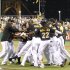 Pittsburgh Pirates' Drew Sutton, center, is surrounded by his team in the bottom of the ninth inning of the baseball game after hitting the game winning home run to lift the Pirates to an 8-7 win over the Houston Astros on Tuesday, July 3, 2012, in Pittsburgh. (AP Photo/Keith Srakocic)