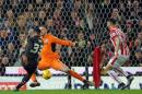 Liverpool's Jordon Ibe, left, scores past Stoke City's goalkeeper Jack Butland, centre, during the first leg of the English League Cup semifinal soccer match between Stoke City and Liverpool at the Britannia Stadium, Stoke on Trent, England, Tuesday, Jan. 5, 2016. (AP Photo/Rui Vieira)