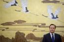 Britain's Prime Minister David Cameron stands before a painting before a signing ceremony at the Great Hall of the People in Beijing