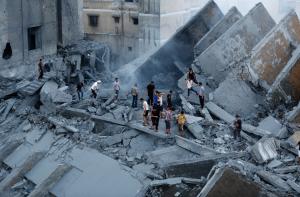 Palestinians inspect the remains of a building destroyed &hellip;