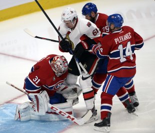 The Canadiens and Senators didn't waste any time renewing unpleasantries in Game 1. (AP)