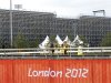 Workers carry scaffolding next to the Riverbank Arena in the Olympic Park in the 2012 Summer Olympics, Sunday, July 15, 2012, in London. The Riverbank Arena will be the hockey competition venue during the Olympics.  (AP Photo/Jae Hong)