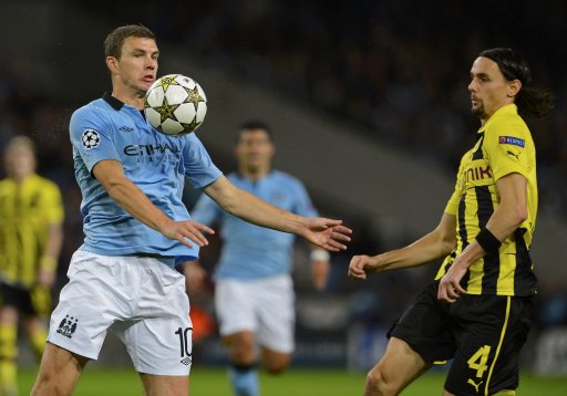 Manchester City's Dzeko is challenged by Borussia Dortmund's Subotic during their Champions League Group D soccer match in Manchester