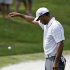 Tiger Woods takes a drop on the fourth hole during the third round of The Players championship golf tournament at TPC Sawgrass, Saturday, May 11, 2013 in Ponte Vedra Beach, Fla. (AP Photo/Gerald Herbert)