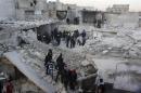 Residents search for survivors at a damaged site after what activists said was an air strike from forces loyal to Syria's President al-Assad in Takeek Al-Bab area of Aleppo