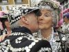 Phyllis Broadbent, the Pearly Queen of Islington, kisses her Pearly King, Jim Broadbent, Pearly King of Islington, outside the Carpenters Arms pub in east London