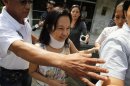 Congresswoman and former Philippine President Gloria Macapagal Arroyo is escorted by her aide as she walks out of the private office after her visit at the graves of her parents inside the military cemetery in Taguig city