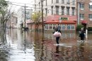 People make their way out of the floodwaters in Hoboken, New Jersey