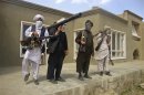Taliban fighters pose with weapons at an undisclosed location in southern Afghanistan