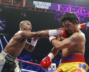 Floyd Mayweather Jr., left, connects with a right to the head of Manny Pacquiao during the first round. (AP)