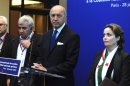 French Foreign Affairs Minister Laurent Fabius, Syrian Opposition Coalition vice-president Riad Seif attend a news conference during the international meeting to support the Syrian National Council, in Paris