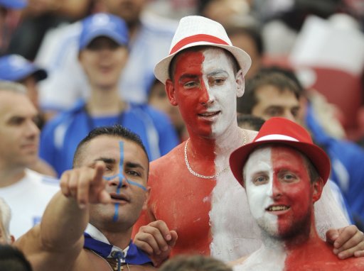 Poland and Greek fans cheer before the start of their Group A Euro 2012 soccer match at the National Stadium in Warsaw